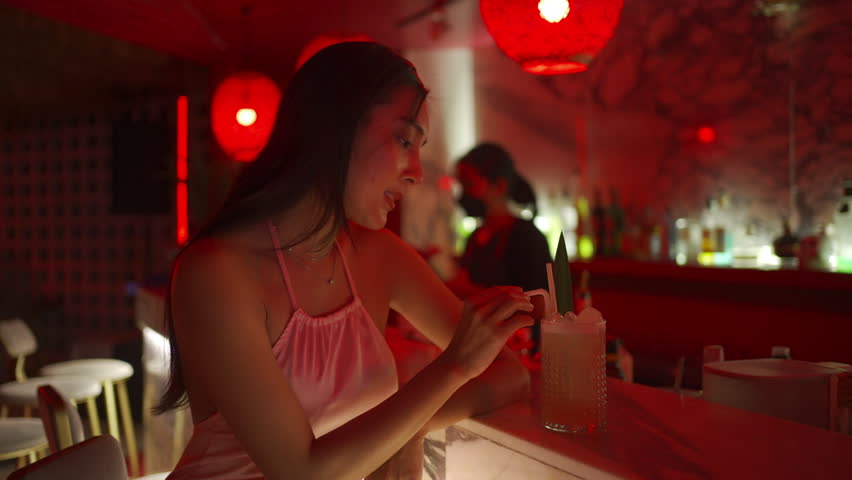 4K Attractive Asian woman relax and enjoy hangout nightlife and drinking fancy cocktail at luxury restaurant bar. Beautiful female celebrating holiday event party at nightclub in the city. | Shutterstock HD Video #1098593083