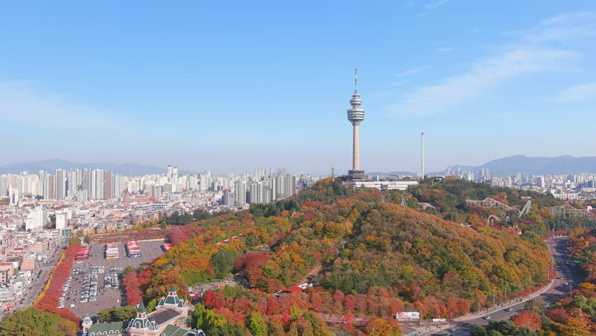 Daegu: Aerial view of Metropolitan City in South Korea, Duryu Park in autumn colors and Daegu 83 Tower, sunny day - landscape panorama of Eastern Asia from above