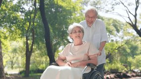 Happy Asian senior man pushing a wheelchair for wife outside in the park, Senior couple and retirement life concept - Powered by Shutterstock - Get 15% off with code: PIKWIZARD15