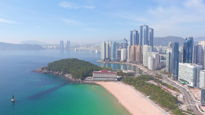 Busan: Aerial view of city in South Korea, skyline with modern high-rise buildings (skyscrapers) and Haeundae Beach, sunny day with blue sky - landscape panorama of Eastern Asia from above