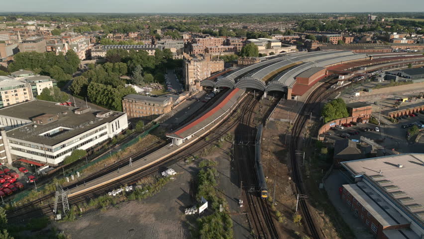 Panning Aerial Drone Shot of York Railway Station with 2 Trains Leaving and Entering the Station with National Railway Museum and River Ouse in View - North Yorkshire United Kingdom