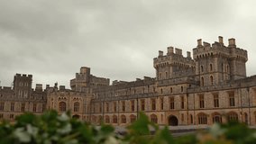 4K video with Windsor Castle in England during a cloudy rainy day, view from the interior courtyard. Landmark historical building symbol for Uk royal.