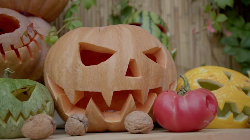 Amazing Halloween decor. Carved faces on garnet and vegetables. Vegetables are all together.