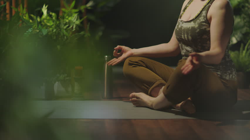 modern woman with yoga mat doing yoga in the modern green house.