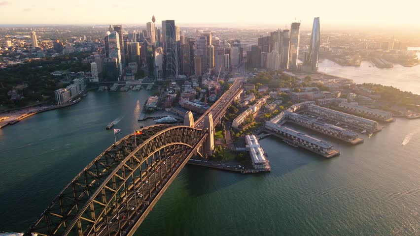Aerial drone pullback reverse view of Sydney City and Sydney Harbour above Sydney Harbour Bridge in the late afternoon   Royalty-Free Stock Footage #1098609153