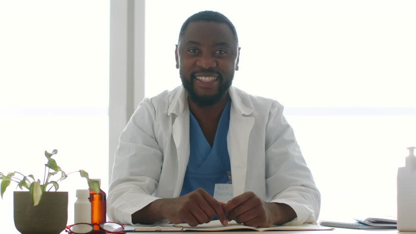 Telemedicine concept. Young professional african american man talking to camera, recording medical blog at office, slow motion Royalty-Free Stock Footage #1098612759