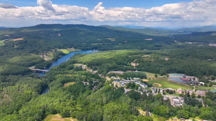 Pemigewasset River and New Hampton historic center aerial view from Hersey Mountain in summer, with White Mountain at the background, New Hampton, New Hampshire NH, USA. 