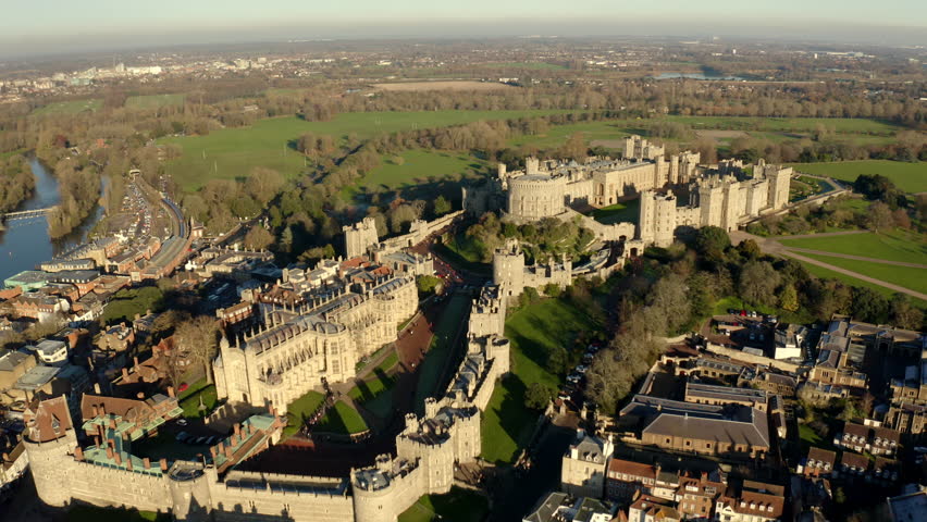 Aerial view of Windsor Castle, royal residence near London - landscape panorama of Great Britain from above, Berkshire, England, United Kingdom, Europe During sunset  Royalty-Free Stock Footage #1098616199