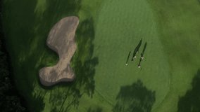 Aerial view of golf players at green field. High quality 4k footage