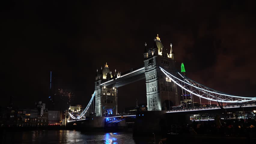 Fireworks next to Tower Bridge landmark building. 4K video with the celebration of the New Year Eve in London.