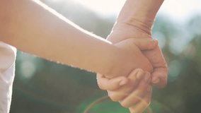 happy family father and daughter hold hands close up. Dad and baby girl hands together at sunset. Father Day. Dad and daughter are holding hands. A father extended a helping hand to his daughter child - Powered by Shutterstock - Get 15% off with code: PIKWIZARD15