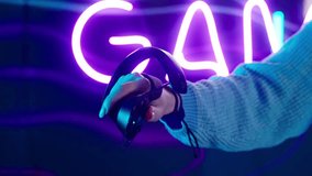 Cyber gamer in VR glasses plays virtual reality game in neon futuristic space. Cyberpunk fashion gaming concept. Man and woman play metaverse virtual digital technology game control with VR goggle. - Powered by Shutterstock - Get 15% off with code: PIKWIZARD15