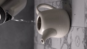 Pouring water in a ceramic teapot with sound. Vertical video. video with sound of pouring water