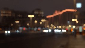 cars drive through the streets in the evening, out of focus video