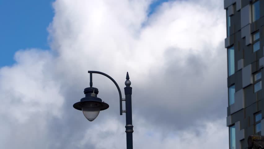 Abstract city view of a streetlight with moving cloud and building facade