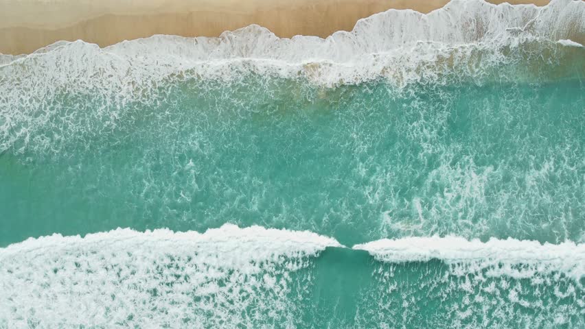 Ocean beach with waves and foam, aerial view. Top view of holiday island | Shutterstock HD Video #1098629695