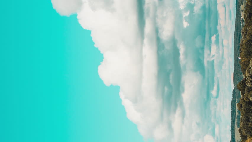 The formation of white clouds in rural hills in retro colors. Vertical video | Shutterstock HD Video #1098636815
