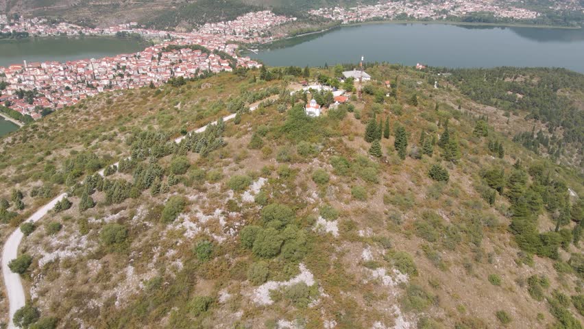 Aerial clip over a mouintain revealing the city and lake of Kastoria, in northern Greece