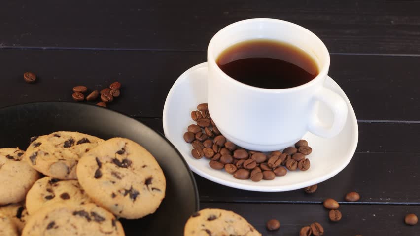 White cup of coffee and chocolate cookie