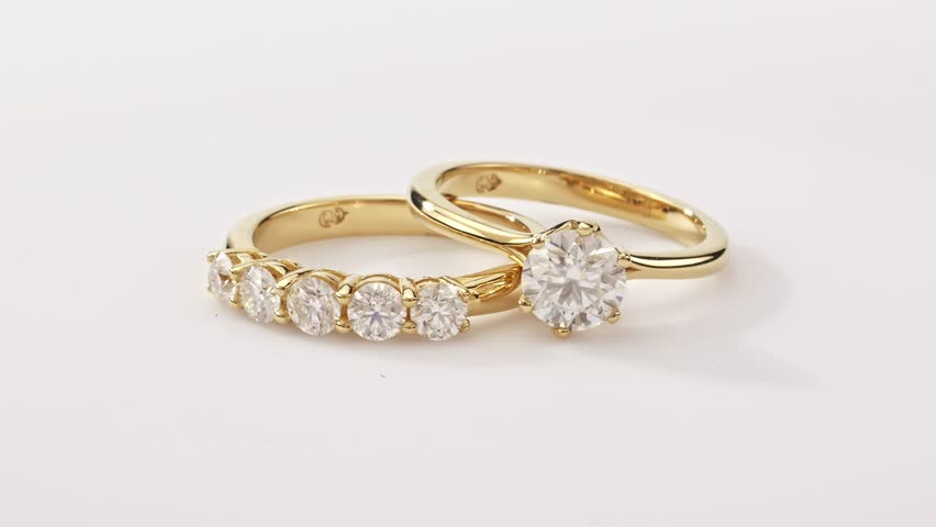 Engagement Gold Rings on White Background