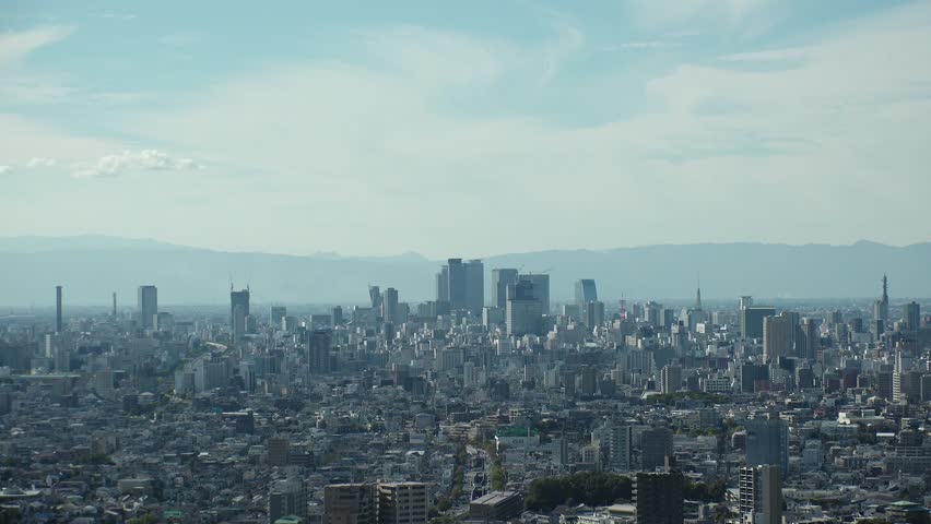 NAGOYA, JAPAN - OCTOBER 2022 : Aerial high angle view of NAGOYA CITY in sunny daytime. View of buildings and street traffic around Nagoya station and Sakae area (central downtown). Time lapse shot.