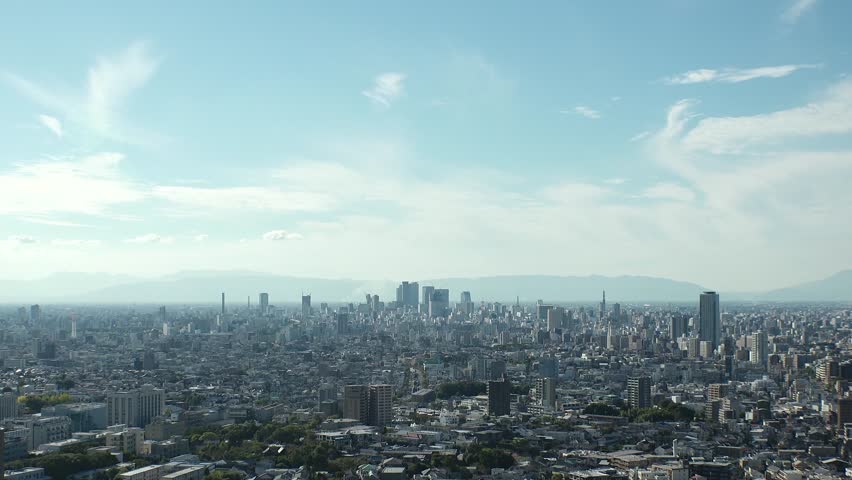 NAGOYA, JAPAN - OCTOBER 2022 : Aerial high angle view of NAGOYA CITY in sunny daytime. View of buildings and street traffic around Nagoya station and Sakae area (central downtown). Time lapse shot.