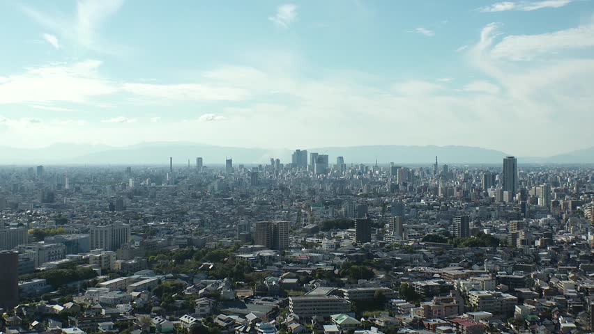 NAGOYA, JAPAN - OCTOBER 2022 : Aerial high angle view of NAGOYA CITY in sunny daytime. View of buildings and street traffic around Nagoya station and Sakae area (central downtown). Time lapse shot.