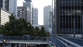 MARUNOUCHI, NAGOYA, JAPAN : View of office buildings around NAGOYA STATION and street traffic in sunset. Time lapse shot, dusk to night. View from the pedestrian bridge. Business concept video.