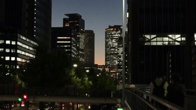MARUNOUCHI, NAGOYA, JAPAN : View of office buildings around NAGOYA STATION and street traffic at night. View from the pedestrian bridge. Travel and business concept video.