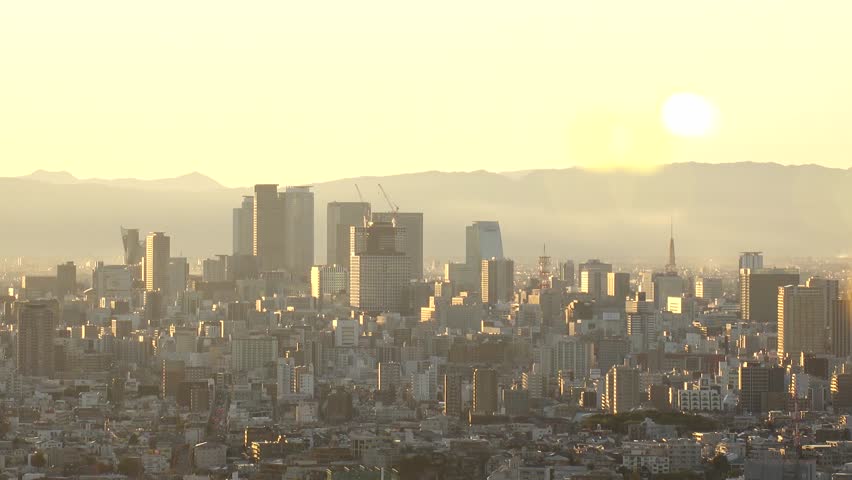 NAGOYA, JAPAN - OCTOBER 2022 : NAGOYA CITY in sunset. Aerial high angle view of buildings and street traffic around Nagoya station and Sakae area (central downtown). Time lapse shot, dusk to night.
