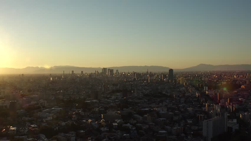 NAGOYA, JAPAN - OCTOBER 2022 : NAGOYA CITY in sunset. Aerial high angle view of buildings and street traffic around Nagoya station and Sakae area (central downtown). Time lapse shot, dusk to night.