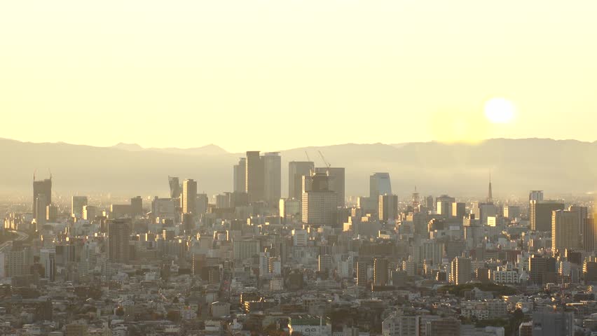 NAGOYA, JAPAN : NAGOYA CITY in sunset. Aerial view of buildings and street traffic around Nagoya station and Sakae area (central downtown). Time lapse shot, dusk to night. Travel and tourism concept.