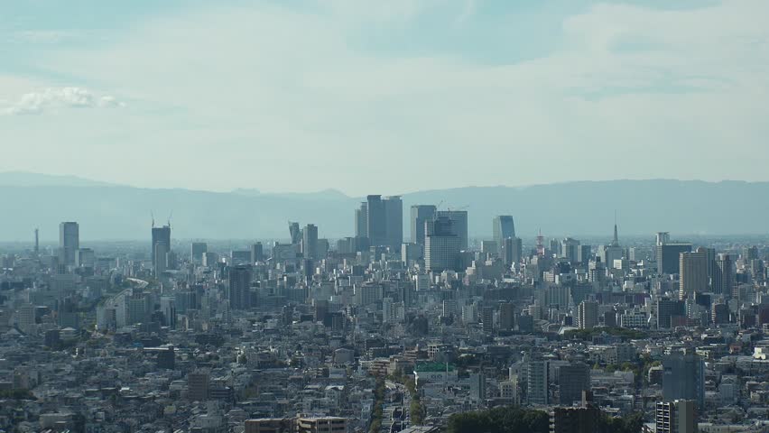 NAGOYA, JAPAN - OCTOBER 2022 : Time lapse shot of NAGOYA CITY in sunny daytime. Aerial high angle view of buildings and street traffic around Nagoya station and Sakae area (central downtown).