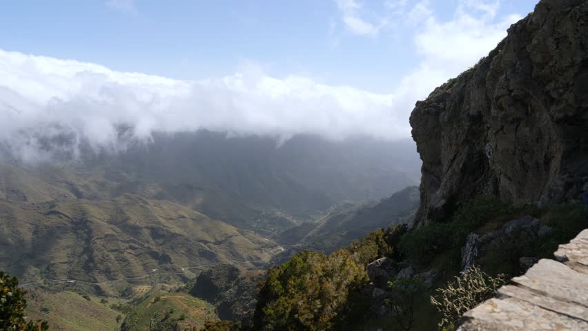 Looking down into a lush valley with a beautiful cloudscape.