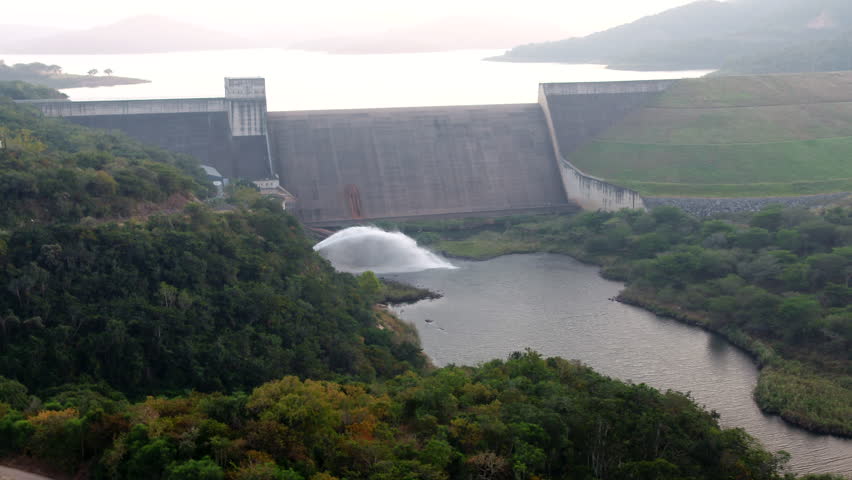 Early morning Drone towards a dam wall releasing water in South Africa.