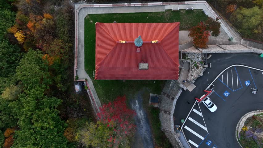 Top down aerial of rooftop of The Pagoda building in Reading Pennsylvania. Forest woodland trees with colorful leaves and foliage in autumn.