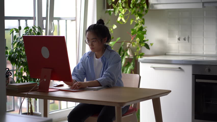 Stressed annoyed Asian woman remote employee throwing papers documents off desk while working from home, unable to complete annoying difficult task. Deadline stress and freelance burnout concept | Shutterstock HD Video #1098650197