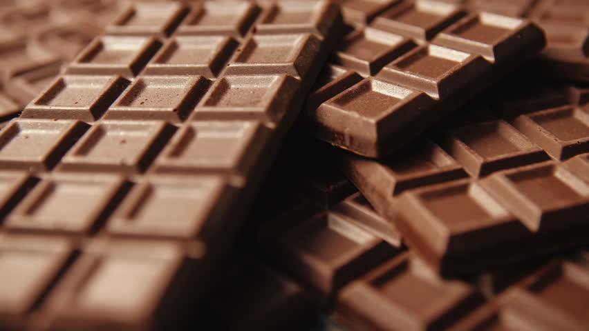 Close-up slide camera chocolate bar, lot of homemade chocolate bars. Handmade chocolate grid texture dolly sliding shot. Confectionery manufacture Royalty-Free Stock Footage #1098650725