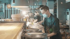 Chefs are wearing face masks while cooking meals - Powered by Shutterstock - Get 15% off with code: PIKWIZARD15