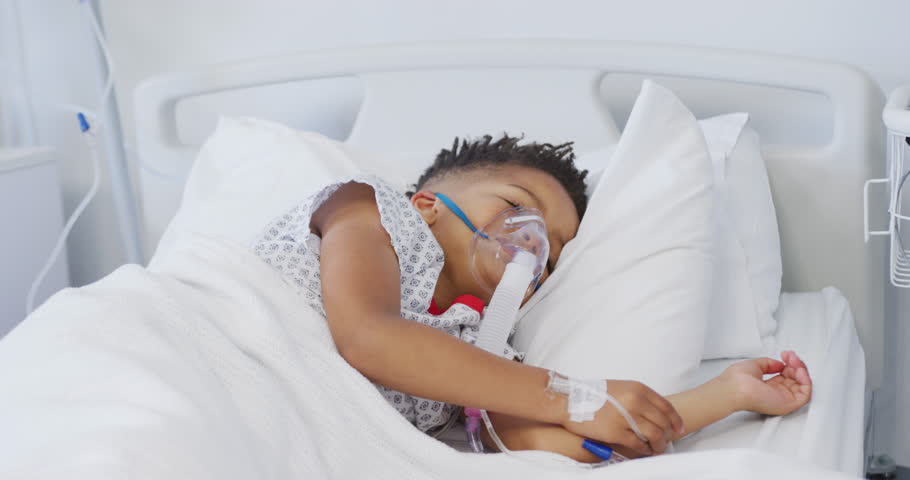 African american boy patient wearing oxygen mask, lying in bed at hospital. Medicine, healthcare, lifestyle and hospital concept. | Shutterstock HD Video #1098652815