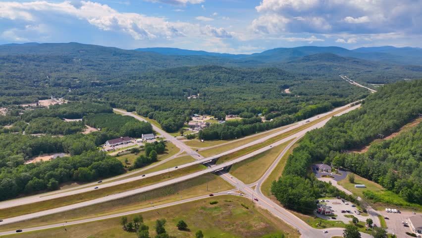 Interstate Highway I-93 at Exit 28 in summer with White Mountain National Forest at the background in town of Campton, New Hampshire NH, USA. 