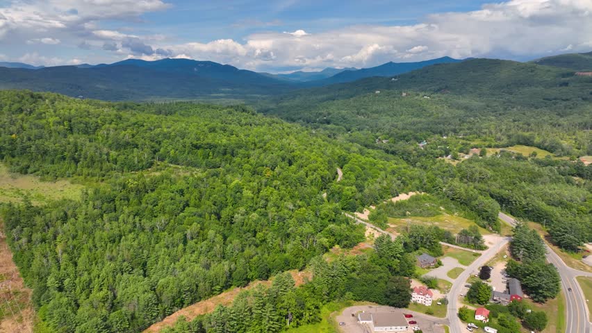 Flying over the Campton Mountain in summer with White Mountain National Forest at the background in town of Campton, New Hampshire NH, USA. 