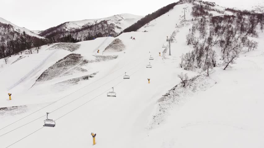 Aerial view winter Bakuriani ski resort panorama in Georgia with steep black slope used for international competitions. Famous travel destination for outdoors skiing