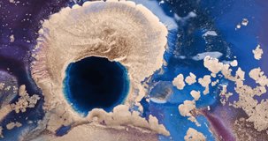 Blue deep hole in gold paint abstract background, close-up. Blue abyss spreads in golden glitter. Bright purple, shiny pink ink art. Colorful gold fluid paint. 4k video. Watercolor liquid backdrop 