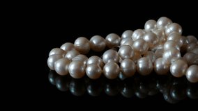 Beautiful pearls necklace on black background rotate, closeup - Powered by Shutterstock - Get 15% off with code: PIKWIZARD15