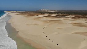 Quad bikes driving on the sandy beach of Boa Vista island. Turle nesting area being damaged by tourist driving on the beach. 4x4 vehicles driving on the paradise beach. Strong winds and high waves