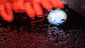 Closeup shot of reflection of city lights in a puddle after the rain. Neon light being reflected on the puddle in the city, Night light background with copy space. Futuristic neon city background.  - Powered by Shutterstock - Get 15% off with code: PIKWIZARD15