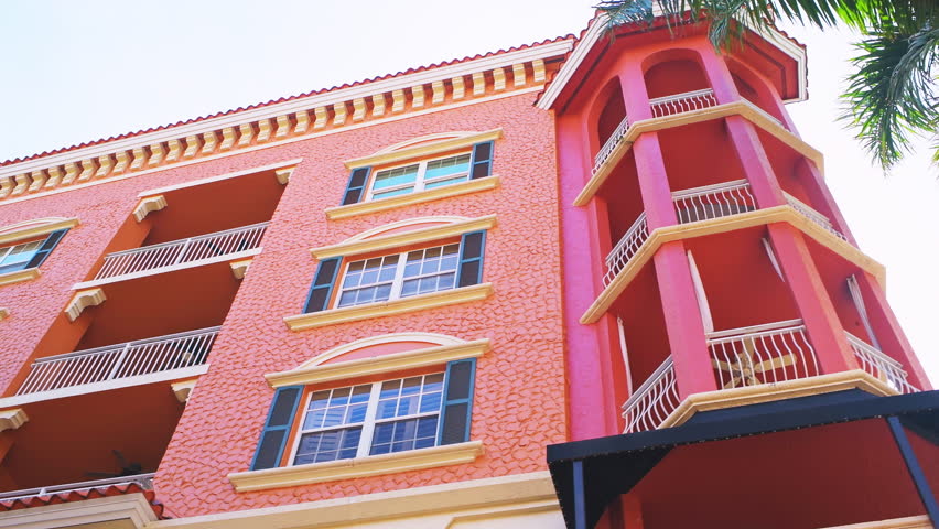 Bayfront residential community with low angle looking up walking handheld pov shot by palm trees at Southwest Florida in Naples, USA