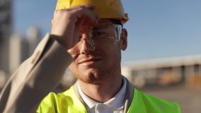 Close Up Portrait of Professional Heavy Industry Engineer, Worker Wear Safety Uniform, Goggles and Hard Hat. In the Background Unfocused Large Industrial Factory - Powered by Shutterstock - Get 15% off with code: PIKWIZARD15