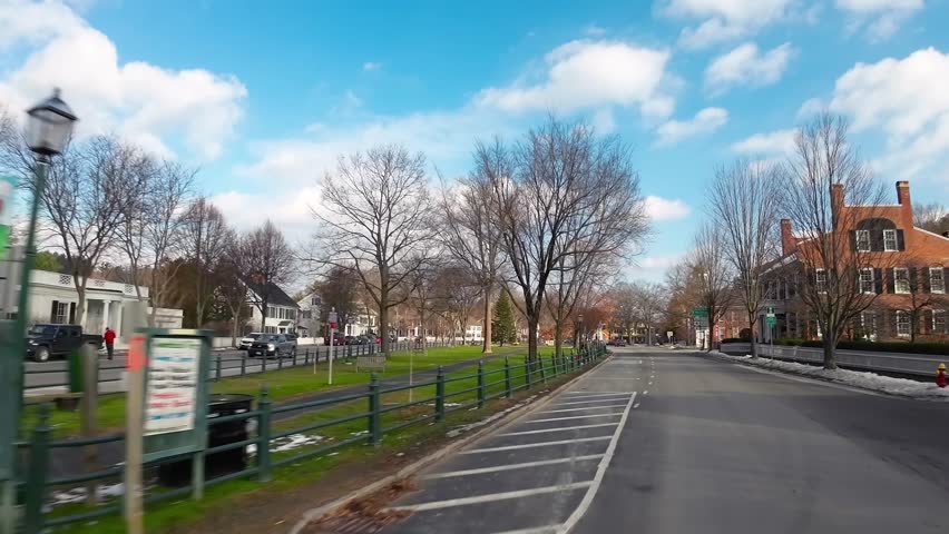 Driving POV through colonial Woodstock town, Vermont New England neighbourhood real estate